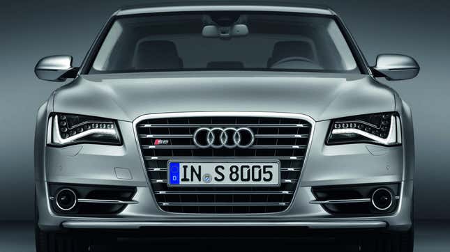 A 2011 Audi S8 in silver shot from a head-on angle displaying its beautiful LED headlight clusters.