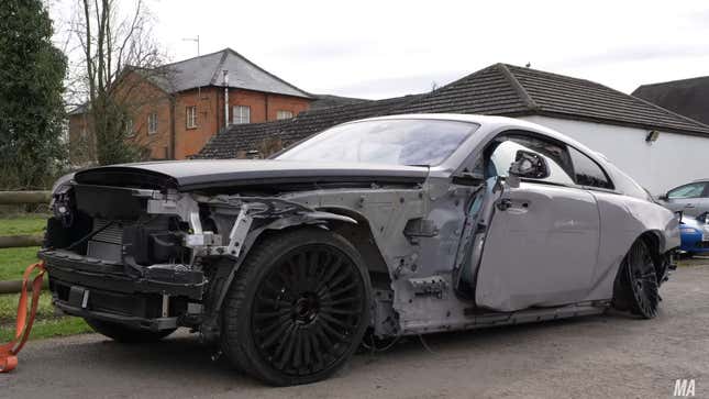 A photo of a trashed Rolls Royce Wraith. 